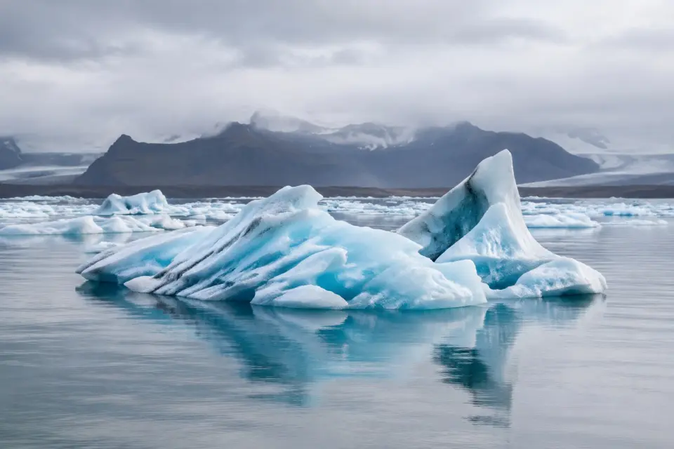 Blue icebergs reflected in an Icelandic glacial lagoon