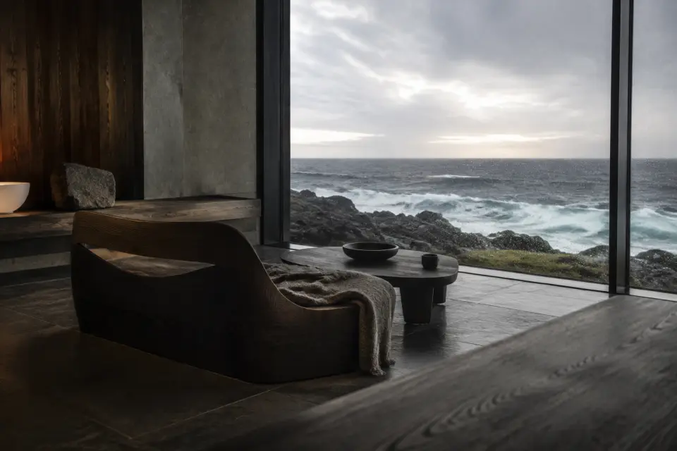 Quiet coastal retreat with a low lounge chair facing the ocean