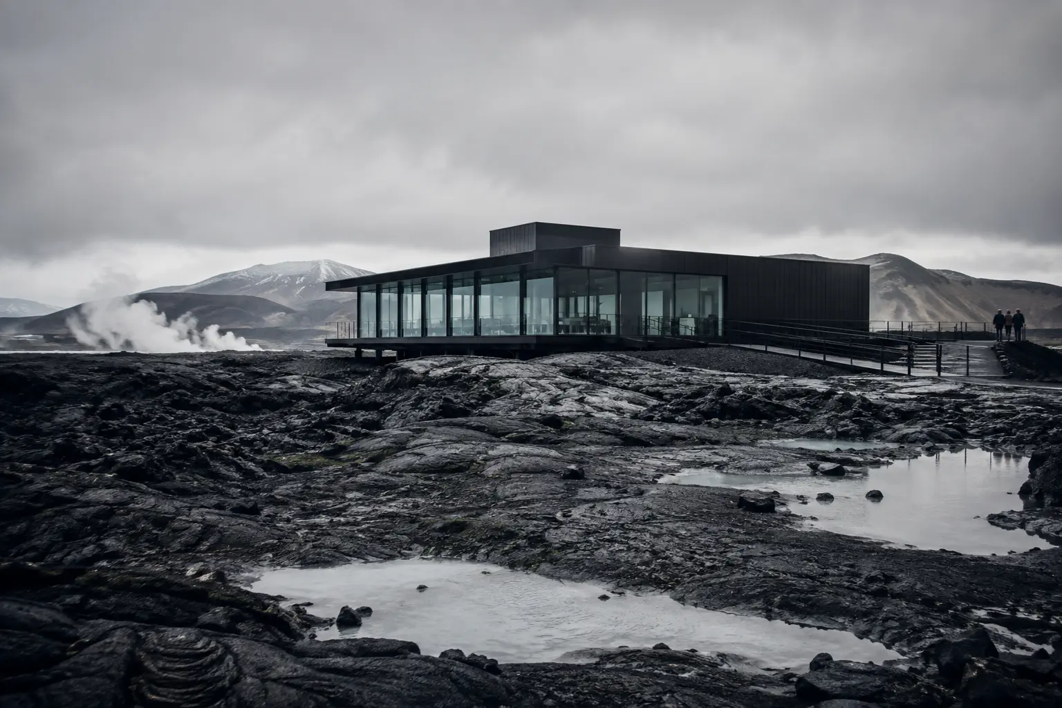 Steam rising from geothermal water between dark basalt walls